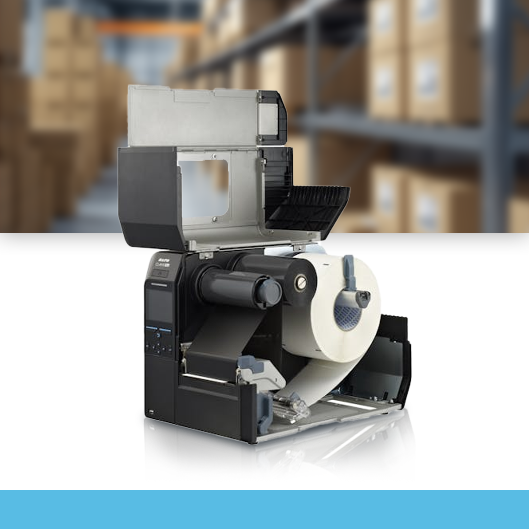SATO CL4NX Plus 609 dpi industrial thermal label printer open cover showing internal mechanism on table in warehouse
