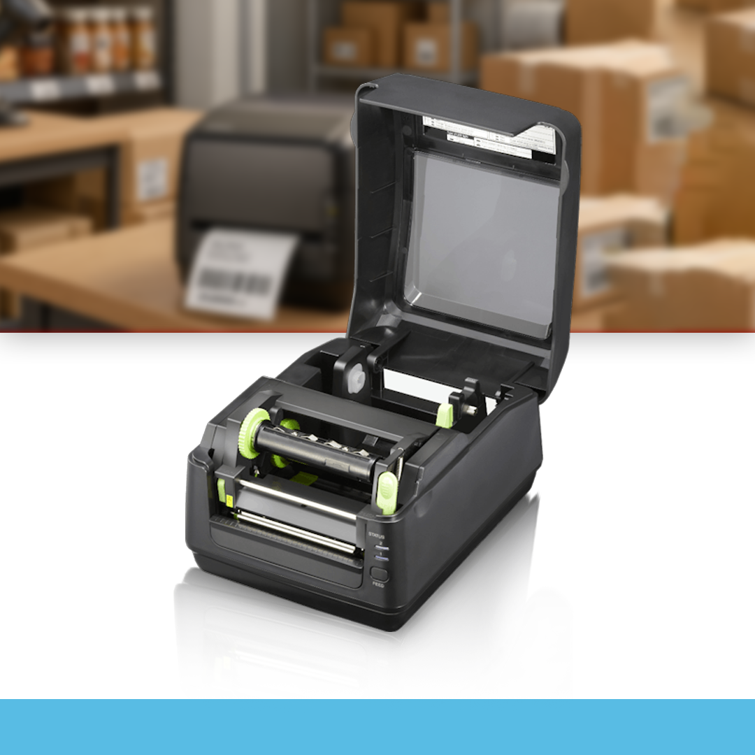 SATO WS4 Direct 300 dpi thermal label printer open cover on table in warehouse with boxes